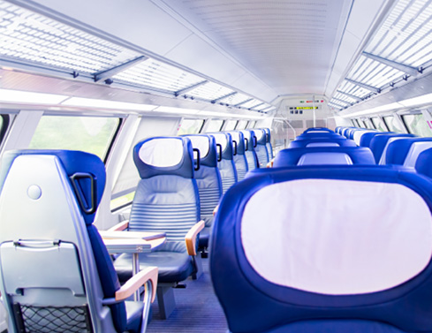 Seats on a train with blue cushions